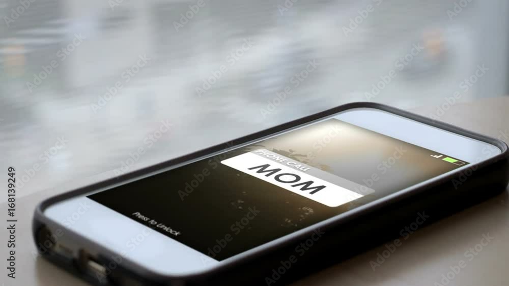 A Mother calling a smartphone with the screen lighting up A Mother calling a smartphone with the screen lighting up