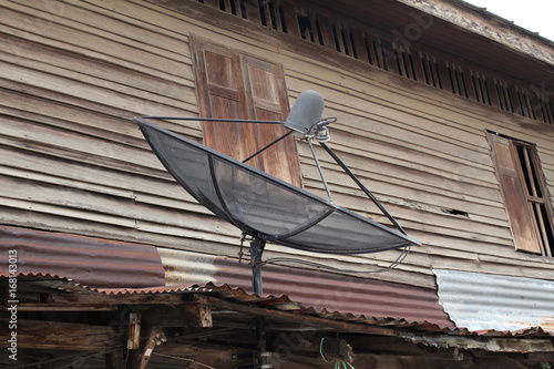 Old wooden house with satellite dishes