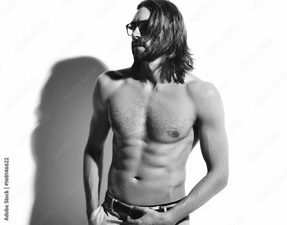 portrait of handsome fashion stylish hipster model man with bare chest in glasses isolated on white