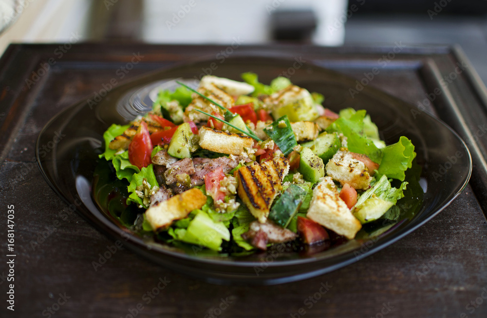 Salad with tomato, meat, cucumber, lettuce and croutons. Healthy food. Fresh food. Tasty food Salad with tomato, meat, cucumber, lettuce and croutons. Healthy food. Fresh food. Tasty food