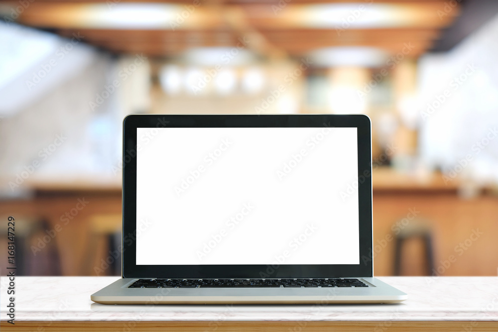 Mock up Blank screen of Laptop on marble table in Co-working or cafe. Mock up Blank screen of Laptop on marble table in Co-working or cafe.