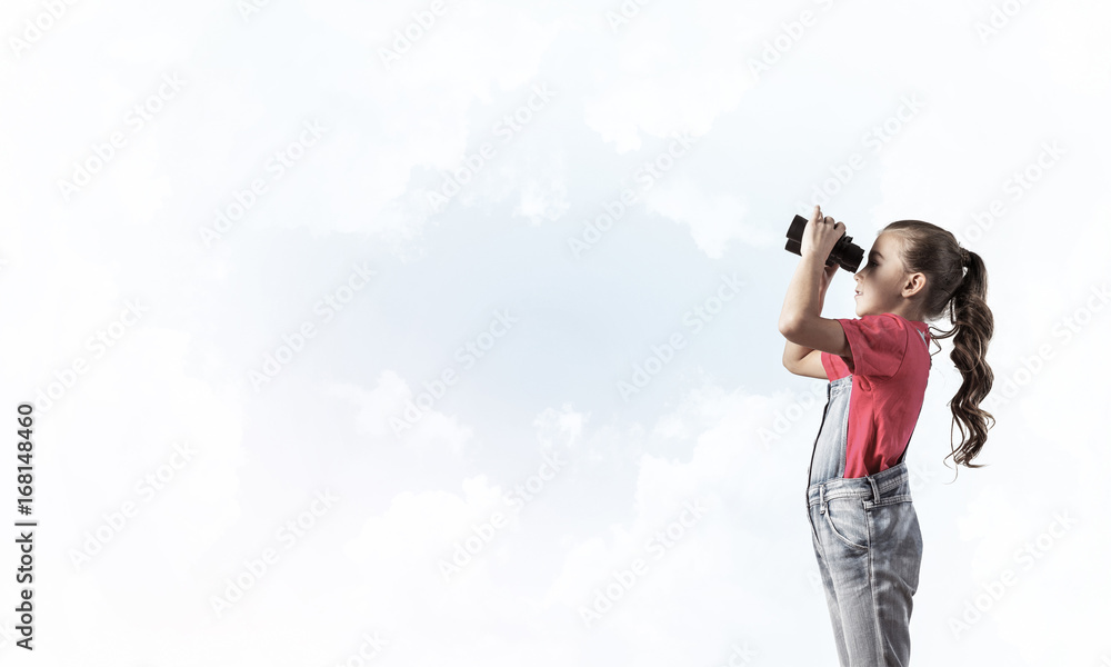 Concept of careless happy childhood with girl looking in binocul Concept of careless happy childhood with girl looking in binocul