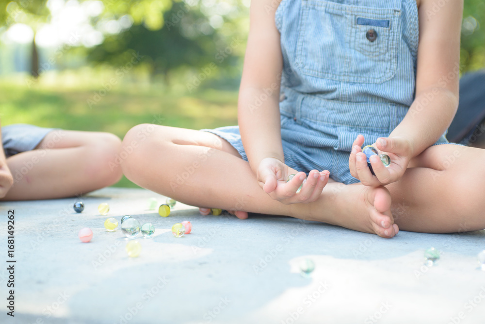 Boy playing marbles game outside Boy playing marbles game outside