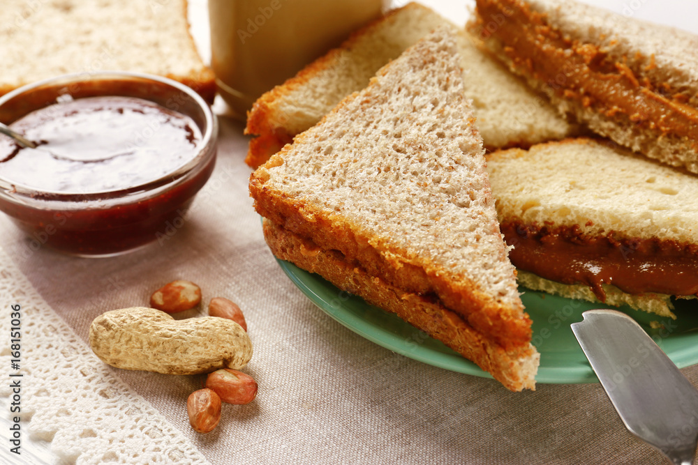 Tasty sandwiches with peanut butter and jam on table Tasty sandwiches with peanut butter and jam on table