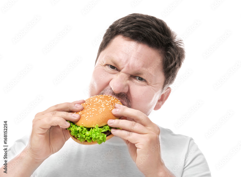 Overweight man eating burger on white background. Diet concept Overweight man eating burger on white background. Diet concept