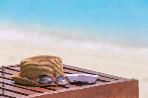 Fototapeta Naklejka Na Ścianę i Meble -  Hat, sunglasses and documents on sun lounger at sea resort. Summer vacation concept