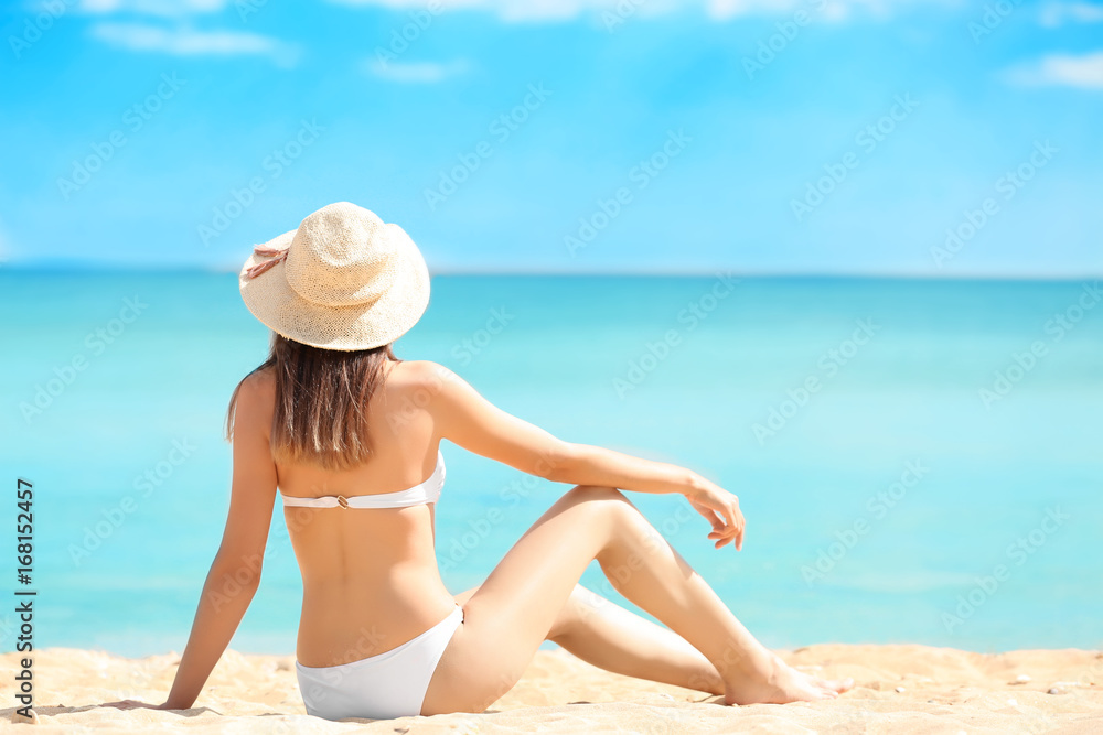 Beautiful young woman in bikini on sea beach Beautiful young woman in bikini on sea beach