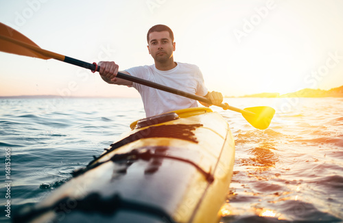 Man kayaker paddling the kayak