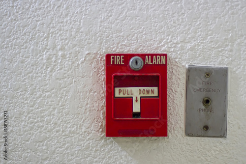 Red antique fire alarm button with white wall