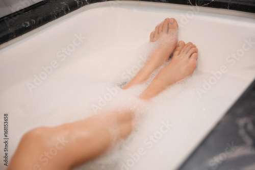 Woman relaxing in bath with foam