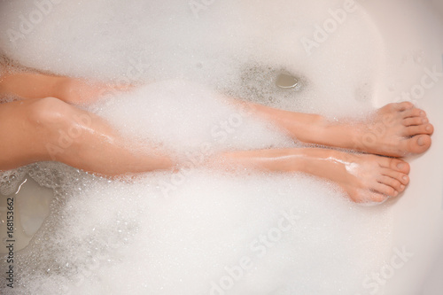 Woman relaxing in bath with foam