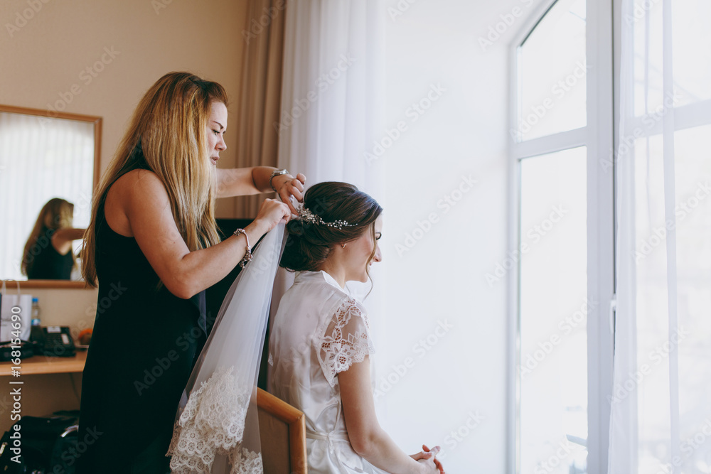 Beautiful bride doing a hairstyle in the morning