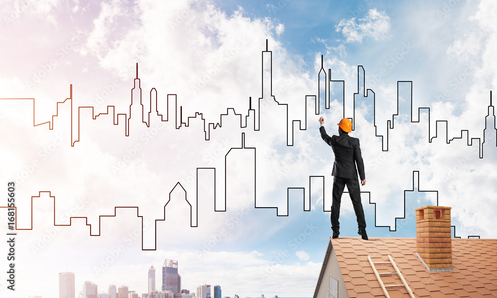 Man architect draw silhouette of modern city on blue sky. Mixed media Man architect draw silhouette of modern city on blue sky. Mixed media
