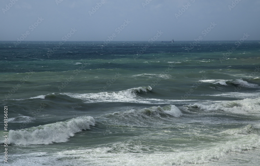 Sea waves at the coastline on a stormy day.