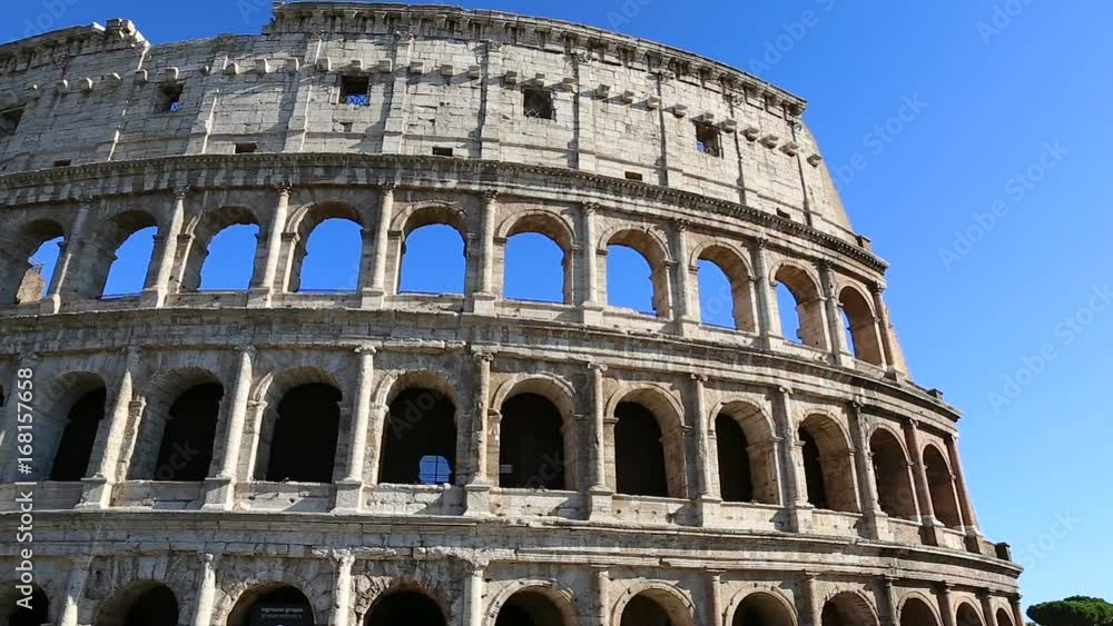 Colosseum, Rome, Italy. Roman Coliseum on summer day with blue sky. Beautiful view of the famous Italian landmark travel icon in the Roman forum. Colosseum, Rome, Italy. Roman Coliseum on summer day with blue sky. Beautiful view of the famous Italian landmark travel icon in the Roman forum.