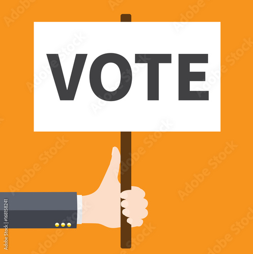 Businessmen holding a signboard with the word VOTE