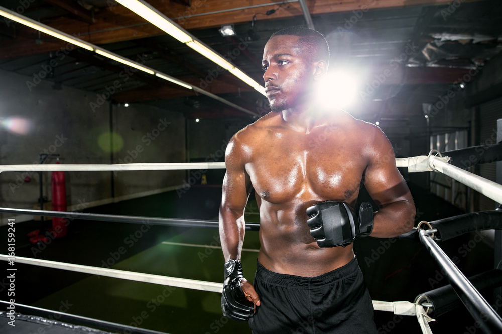 African american fighter in action dancing around the ring ready to fight and strike opponent African american fighter in action dancing around the ring ready to fight and strike opponent