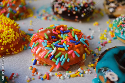 American donuts with the colorful crumbs sprinkled on the top. Colorful crumbs are giving amazing look to the american donuts.