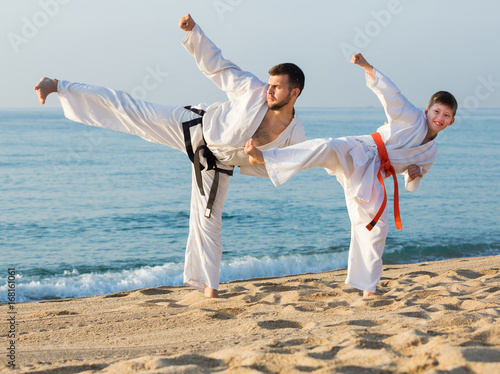 Man and boy exercising karate photo