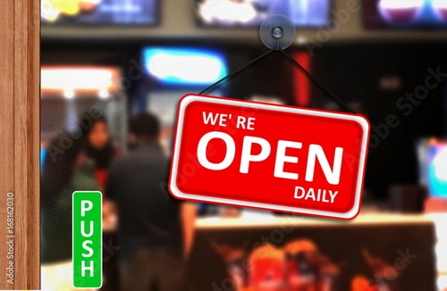 We are open daily sign on shop glass door