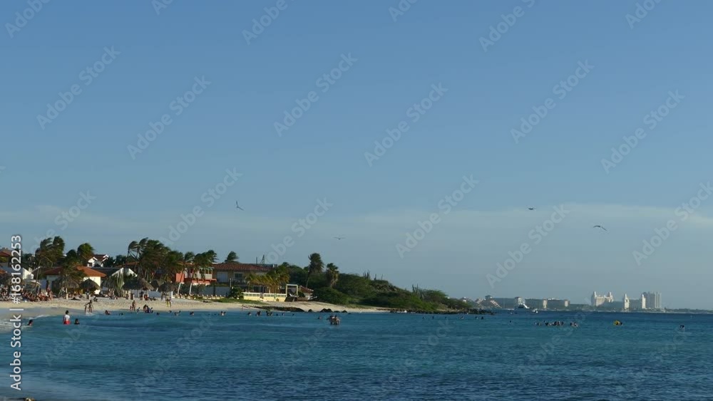 Arashi Beach on Aruba with hotel skyline at the background Arashi Beach on Aruba with hotel skyline at the background