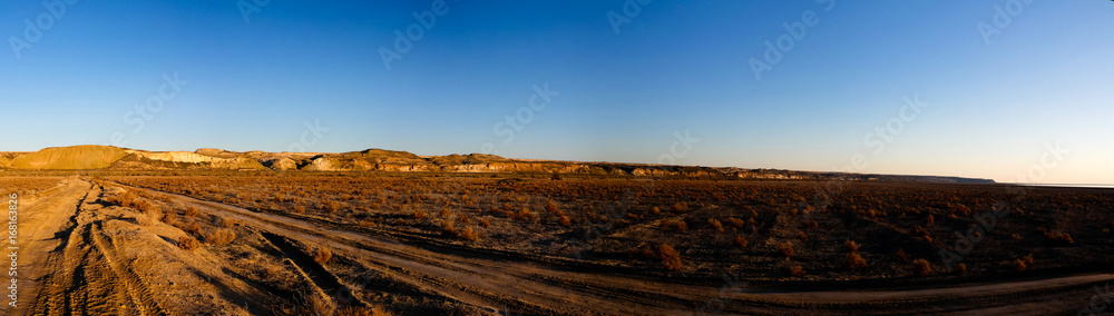 Panorama view to Plateau Ustyurt from the edge of Aral sea near Aktumsuk cape at sunrise, Karakalpakstan, Uzbekistan Panorama view to Plateau Ustyurt from the edge of Aral sea near Aktumsuk cape at sunrise, Karakalpakstan, Uzbekistan