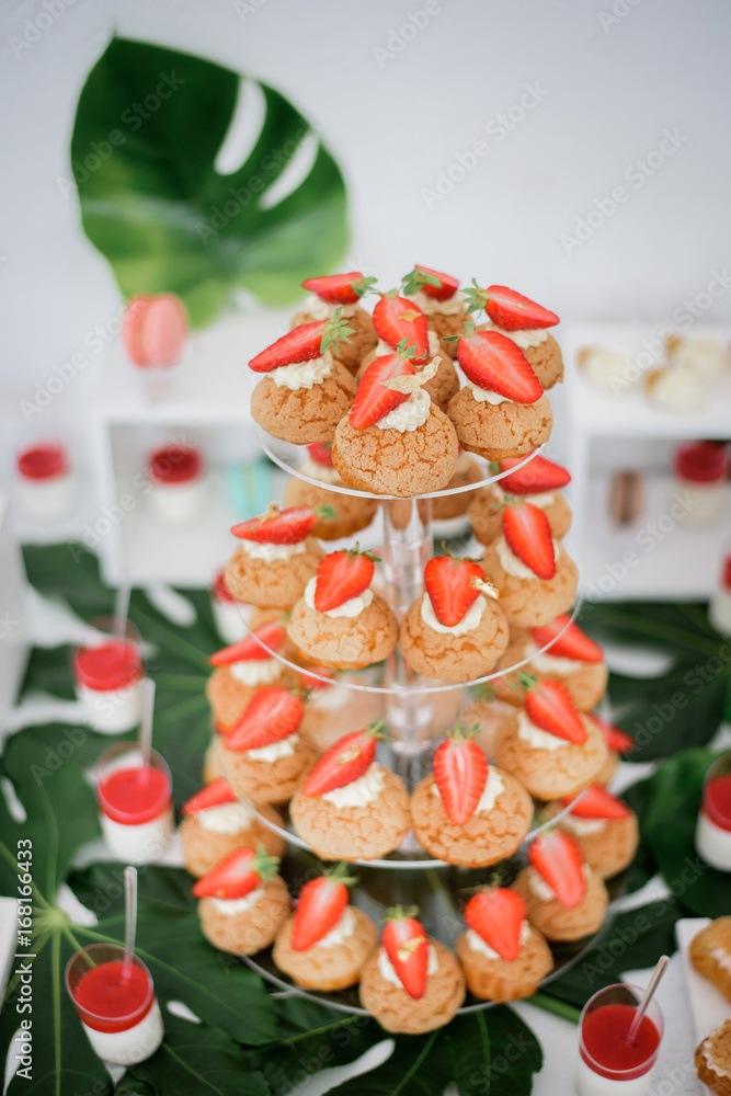 Strawberry eclairs served on transparent dish
