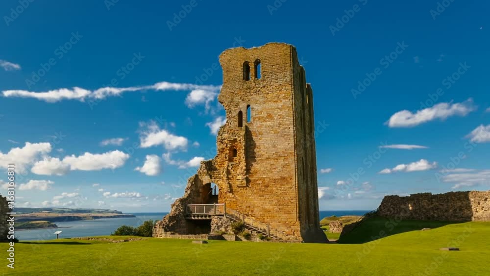POV gimbal shot towards the medieval Scarborough Castle during sunset golden hour against a bright blue sky, Yorkshire, England, UK POV gimbal shot towards the medieval Scarborough Castle during sunset golden hour against a bright blue sky, Yorkshire, England, UK