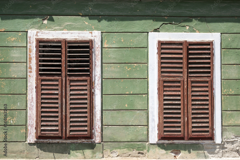Detail of facade with old windows in rustic ancient house in Sibiu city, Romania Detail of facade with old windows in rustic ancient house in Sibiu city, Romania