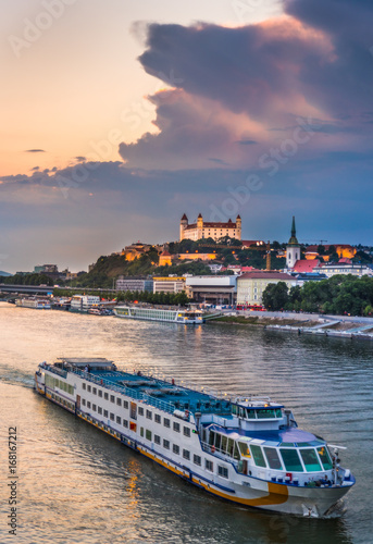 Cityscape of Bratislava, Slovakia at Sunset as Seen from a Bridge over Danube River with a Passenger Ship towards Btatislava Castle
