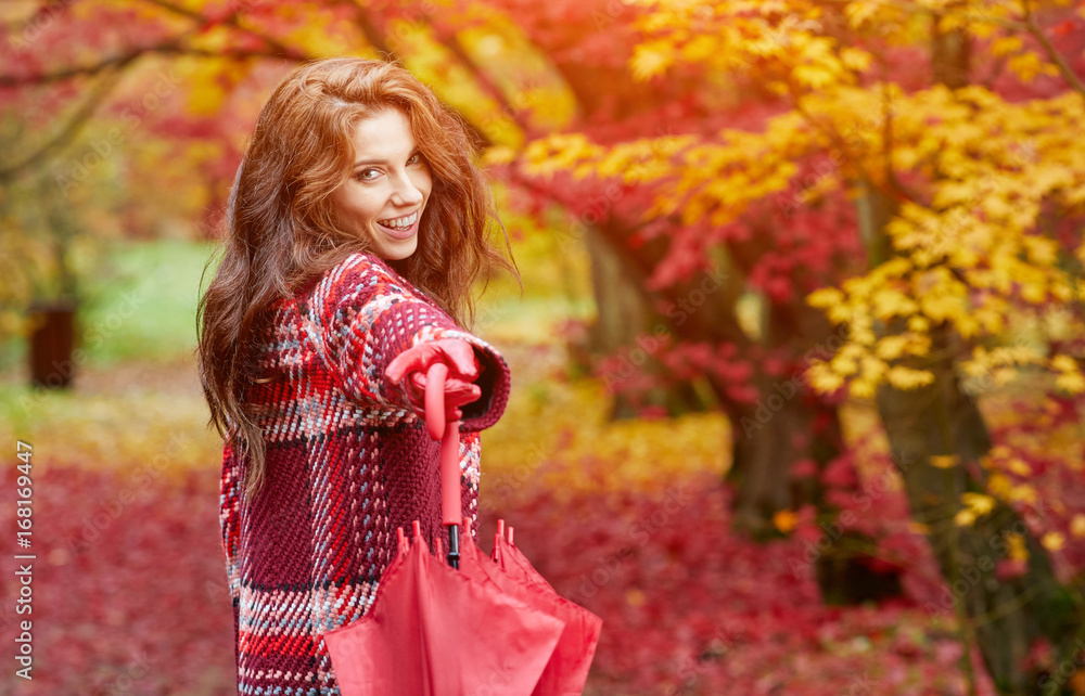 Autumn woman in autumn park with red umbrella, scarf and leather gloves Autumn woman in autumn park with red umbrella, scarf and leather gloves