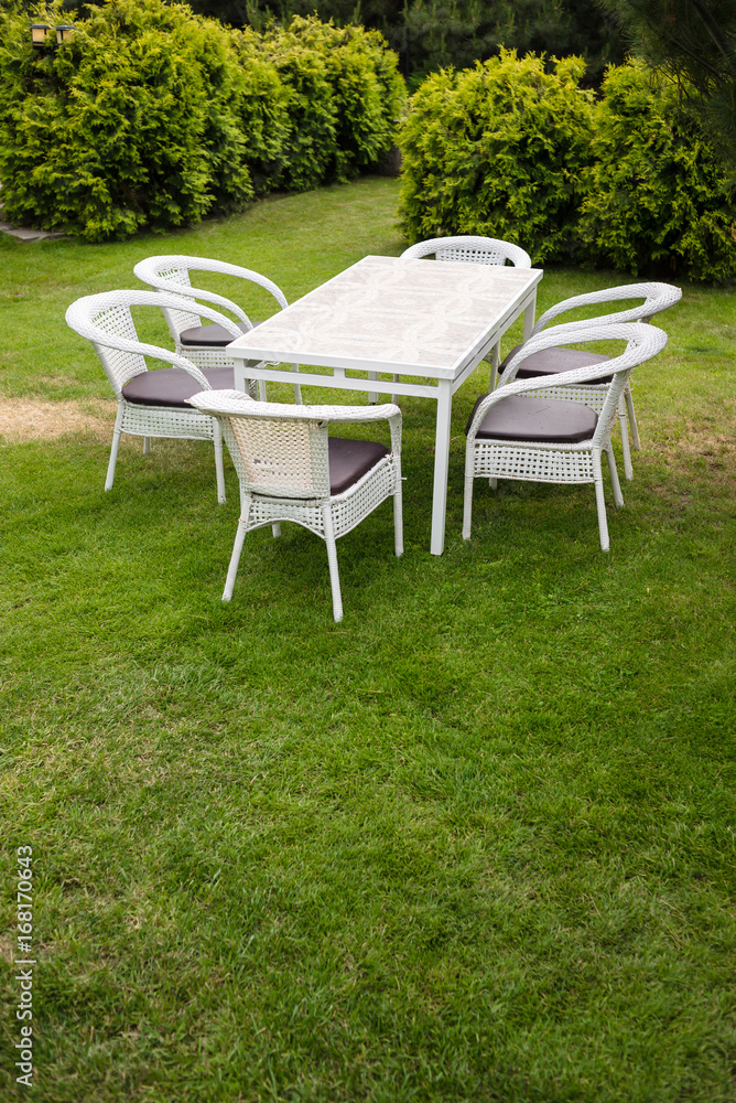 White garden furnituse sofa armchair table on the lawn White garden furnituse sofa armchair table on the lawn