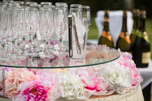 set of champagne bottles, glasses, ice, decorations and forceps outdoor service catering