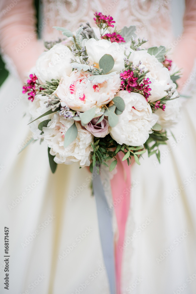 Bride holds rich wedding bouquet in her arms Bride holds rich wedding bouquet in her arms