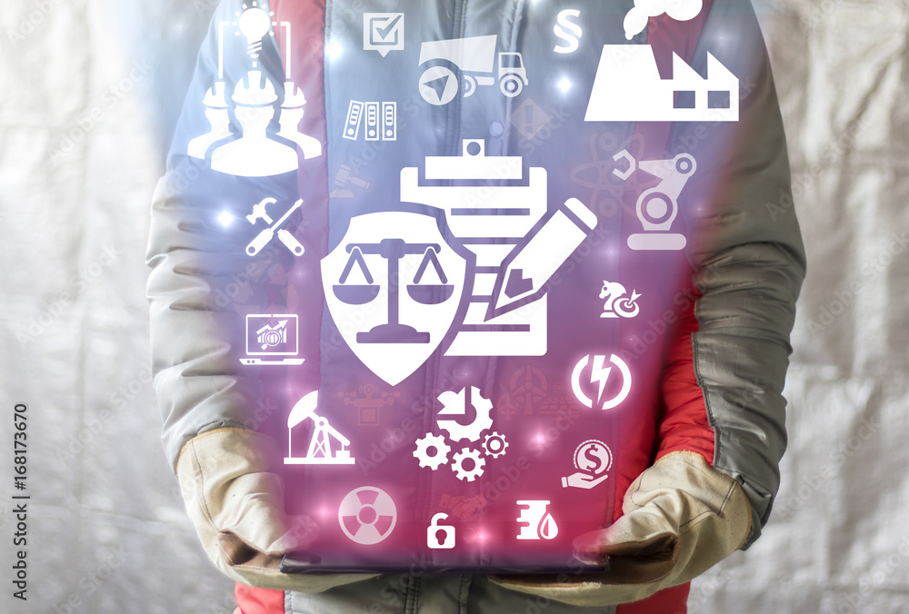 Compliance Industrial concept. Worker man offers tablet computer with check list pencil shield scales icon on a virtual graphical user interface. Compliance Industrial concept. Worker man offers tablet computer with check list pencil shield scales icon on a virtual graphical user interface.