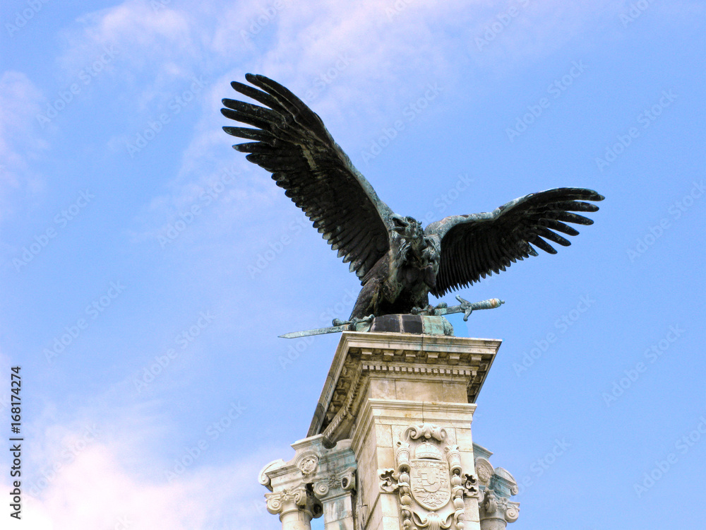 Vulture, mythical Turul. Sculpture of vulture with spread wings with the royal sword in its claws. It is the legendary bird Turul, a symbol of the Arpad dynasty - the founders of the Hungarian state.