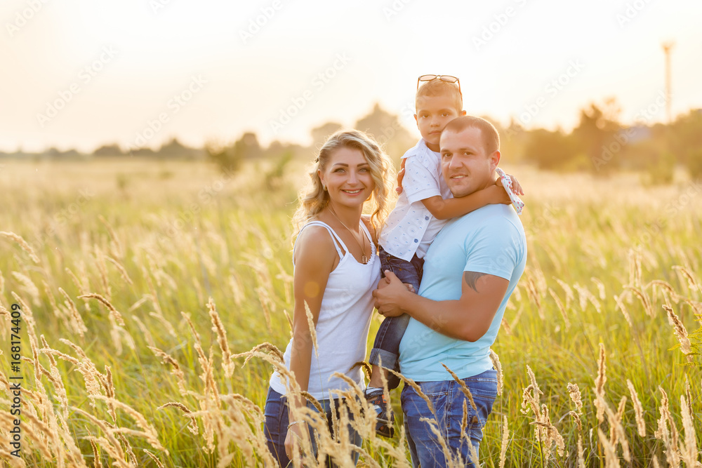 Beautiful family in a field of spikelets