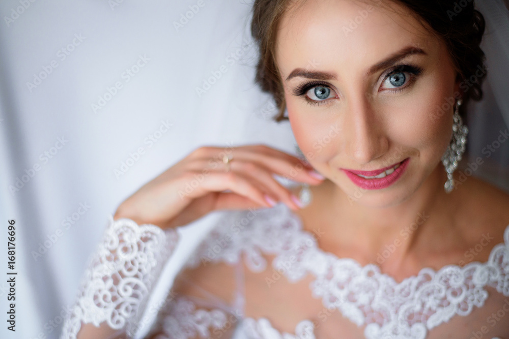 Portrait of blue-eyed bride with pink lips