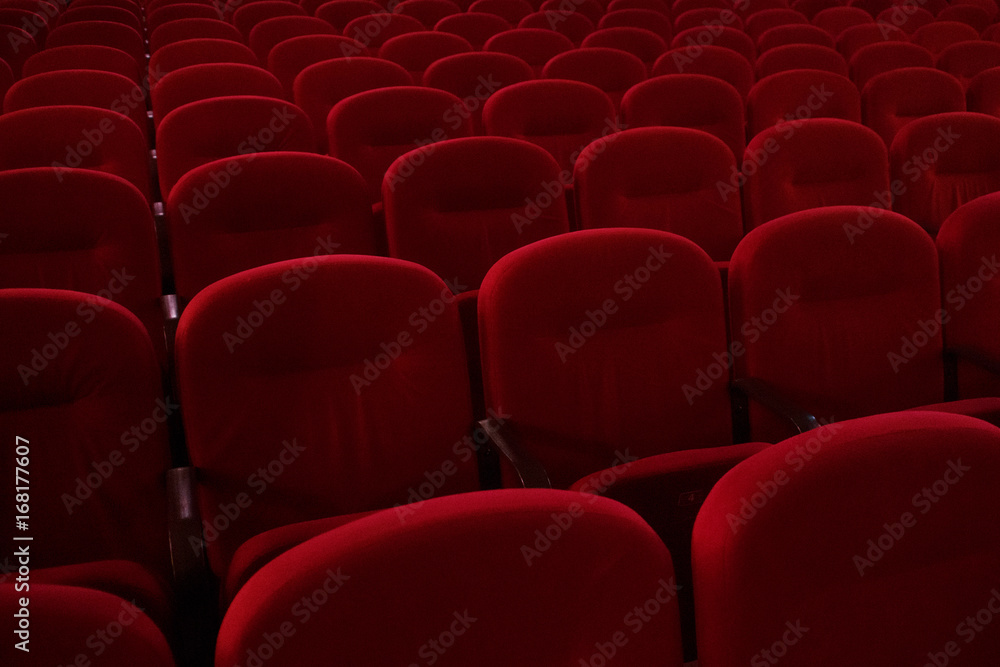 Obraz premium Empty cinema hall. Rows of red chairs. The crisis in film distribution