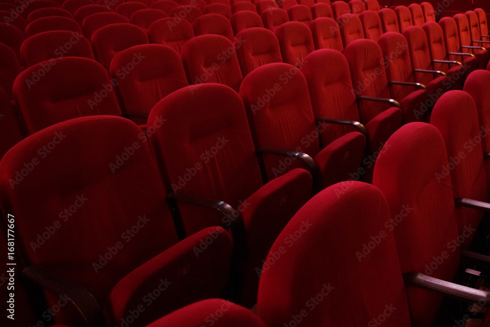 Empty rows of red theater or movie seats, side view