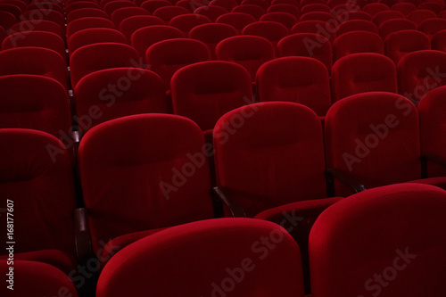 Empty cinema hall. Rows of red chairs. The crisis in film distribution