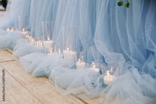 Decoration of the table with chiffon and lighted candles