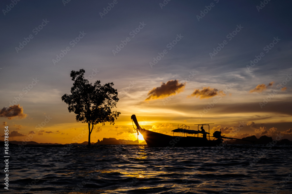 Silhouette of thai long tail boat on the sea at the sunset, Khlong Muang beach, Krabi, Thailand