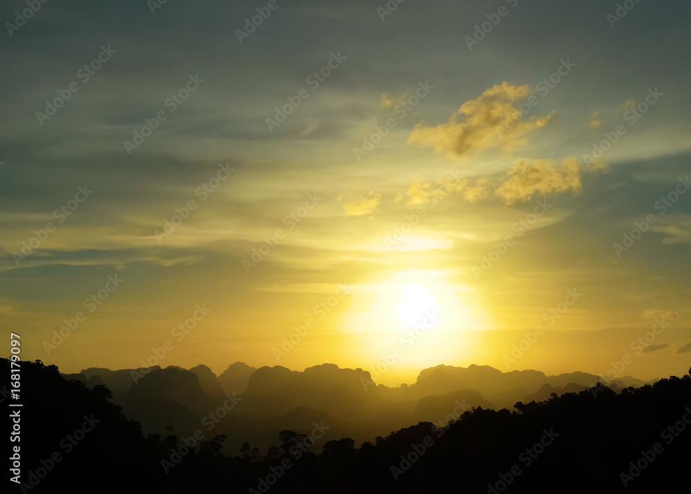 Low key image of sunset over the mountains. Krabi, Thailand.