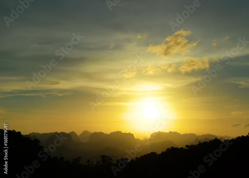 Low key image of sunset over the mountains. Krabi, Thailand.