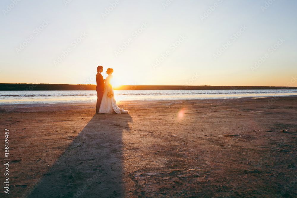 Groom and bride on a walk outdoors at the sea