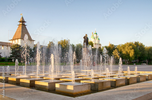 Astrakhan, summer evening. Lenin square with a fountain. Astrakhan Kremlin and the Assumption Cathedral in the background