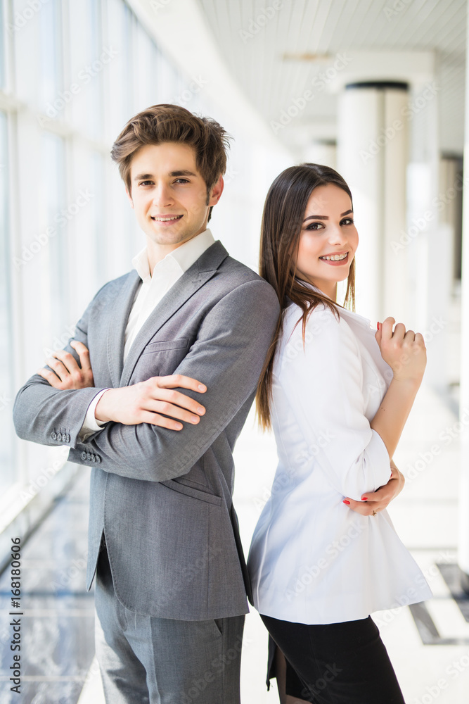 Confident business team of man and woman standing with crossed hands, team spirit concept, couple of success business people ready to act, business manager and employee,ready to implement plans Confident business team of man and woman standing with crossed hands, team spirit concept, couple of success business people ready to act, business manager and employee,ready to implement plans