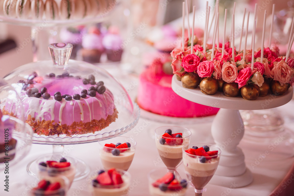 Glass dishes with cupcakes, cold desserts and other sweets