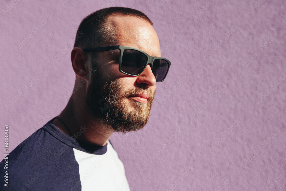 Hipster man wearing black sunglasses in urban city streets Hipster man wearing black sunglasses in urban city streets